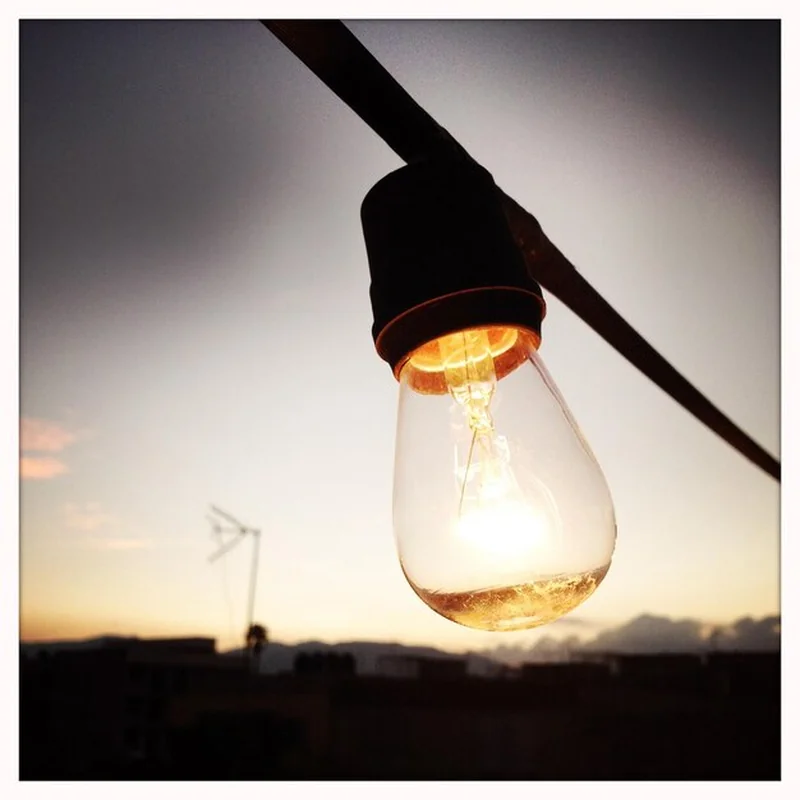 Żarówka na tle nieba w zmierzchu